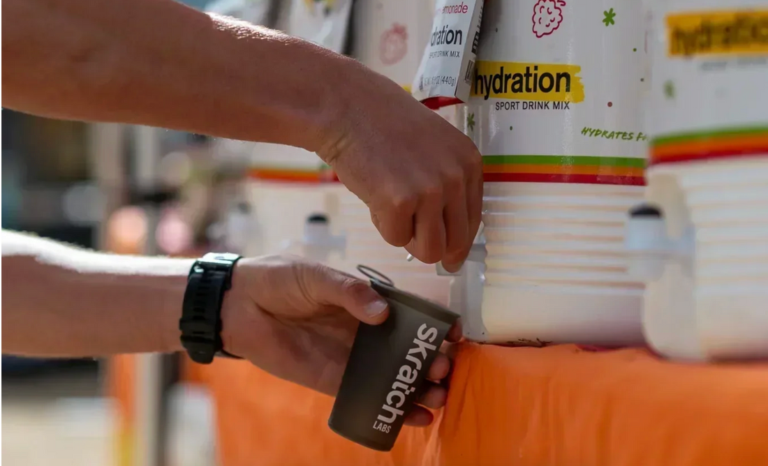 Athlete refilling drink at ultramarathon race