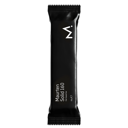 A single black Maurten Solid 140 energy bar wrapper, shown vertically against a solid white background.