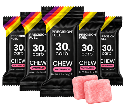 Five packs of Precision Fuel Chew gum in Watermelon flavor, arranged in a fan shape with two pink chewable tablets in front, on a solid white background.